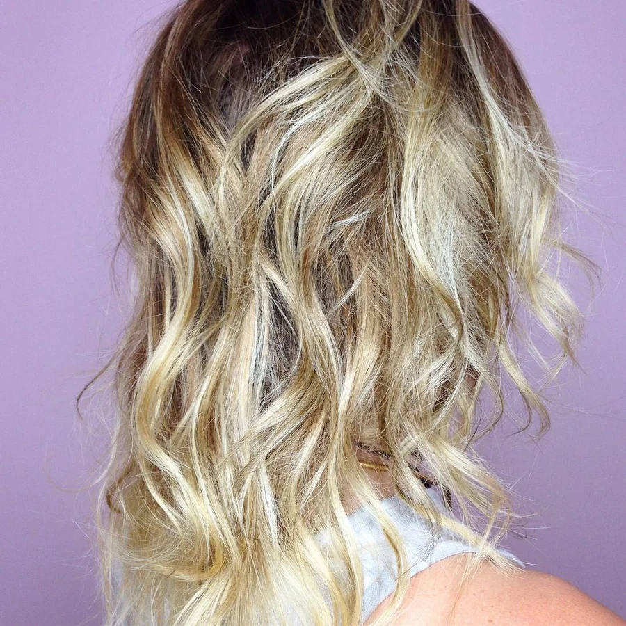 Deva cut with blonde balayage on long waves by Richie at Damron & Company Salon in Austin