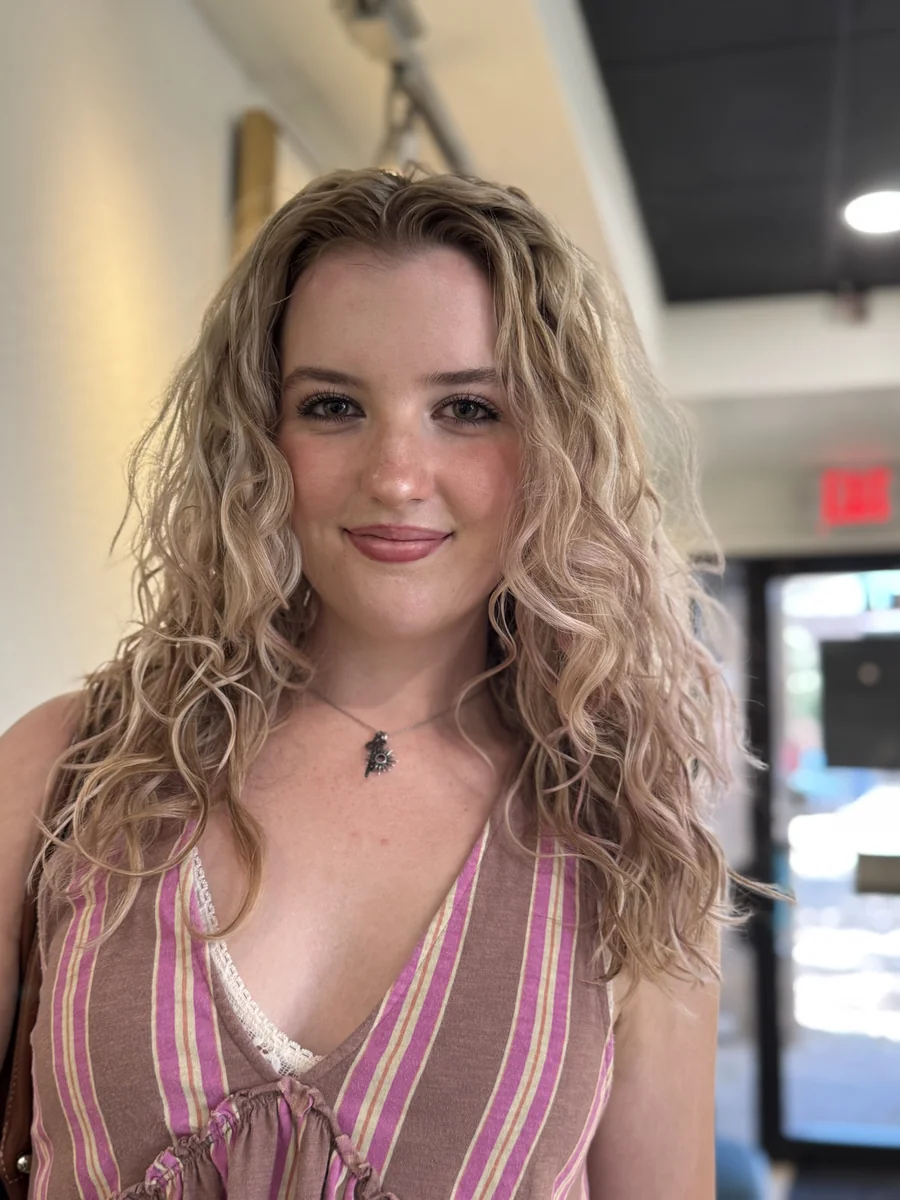 Deva cut with highlights on long blonde waves, smiling client by Richie at Damron & Company Salon in Austin