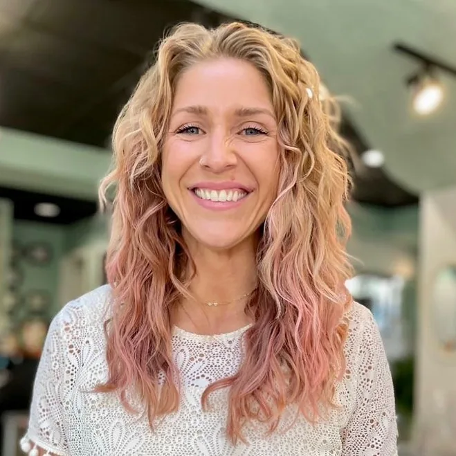 Deva cut with pink ombre color on long blonde waves, smiling client by Richie at Damron & Company Salon in Austin