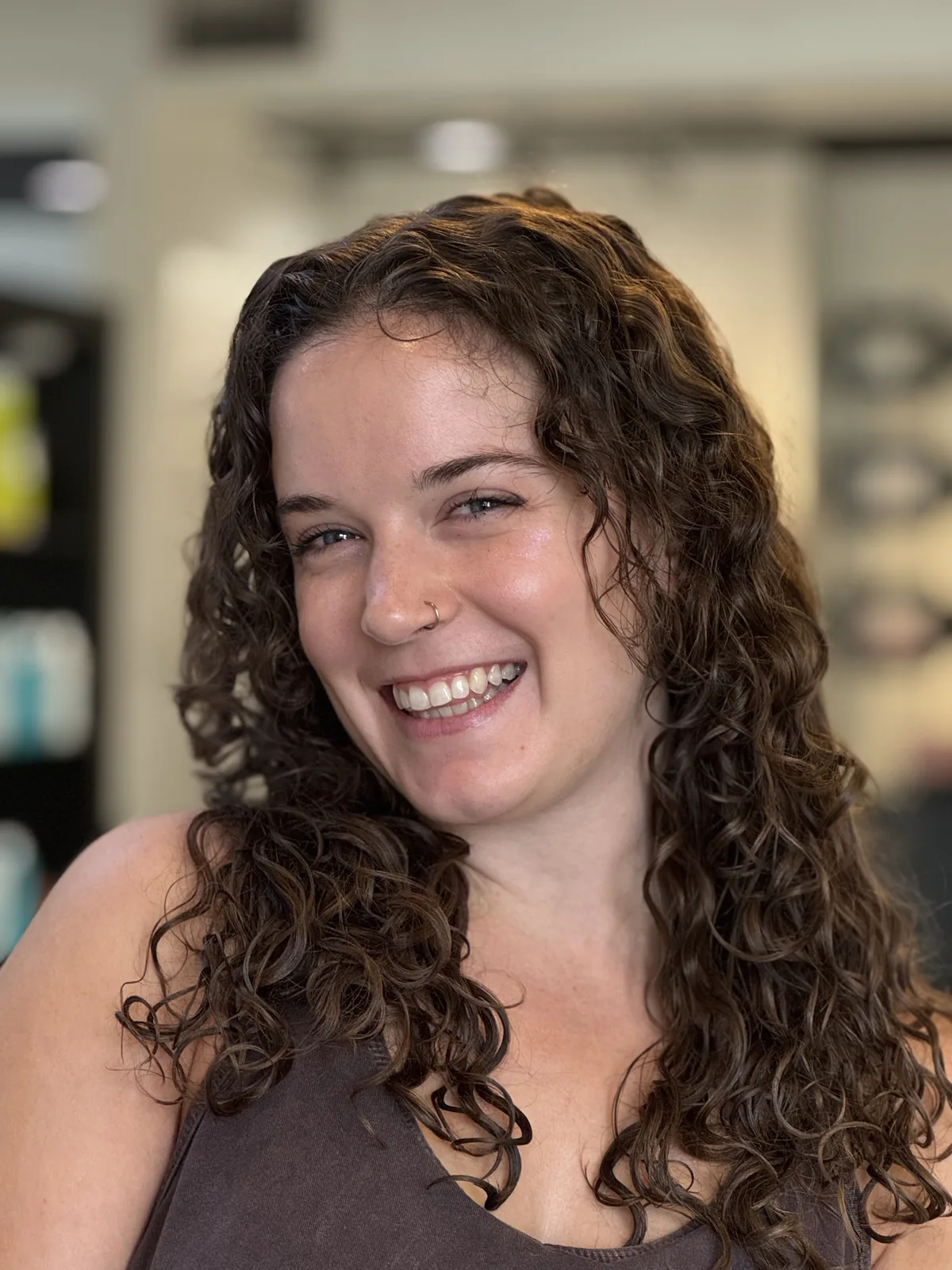 Deva cut with long layers on long brown ringlet curls, laughing client by Richie at Damron & Company Salon in Austin