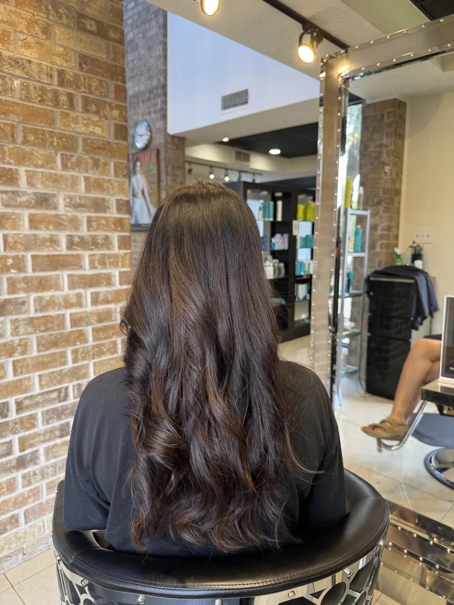 Hair botox deep-conditioning treatment with a haircut, silky restored shine on long dark hair, back view by Richie at Damron & Company Salon in Austin