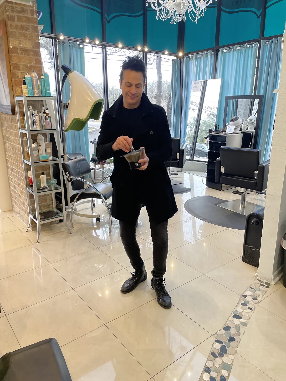 Richie mixing color inside Damron & Company Salon in Austin