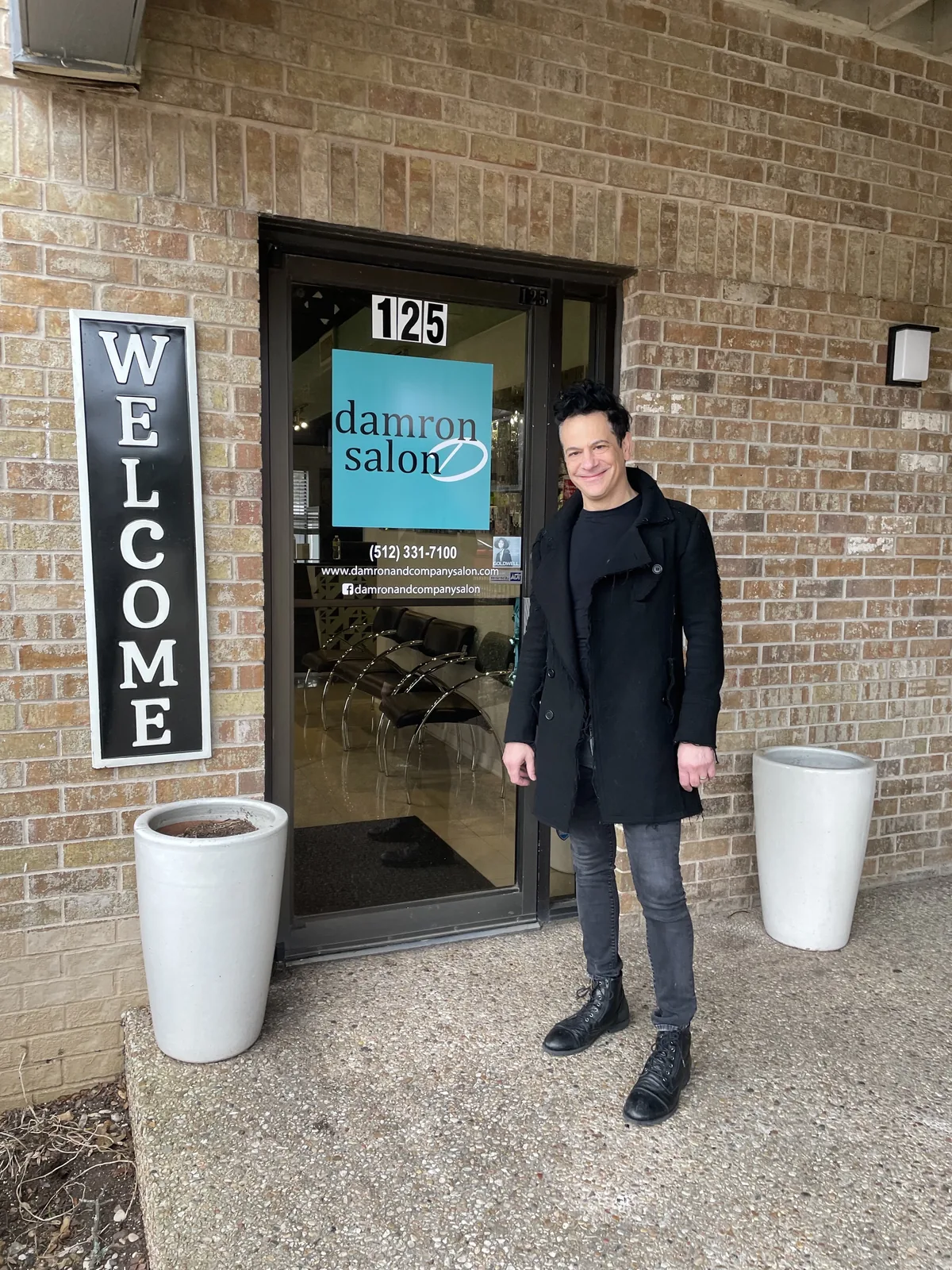 Richie at the entrance of Damron & Company Salon in Austin